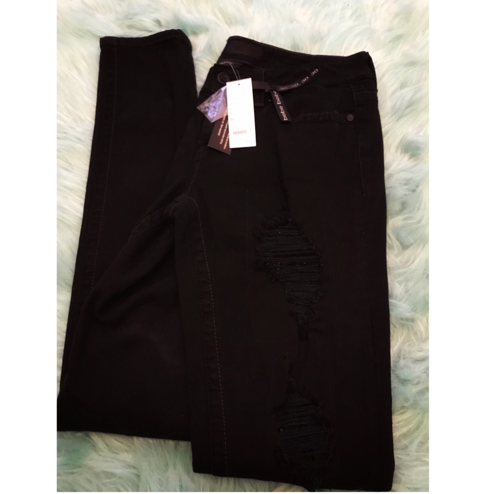 bebe rhinestone flap back pocket skinny jeans..
